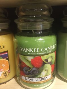 an assortment of yankee candles are on the shelf