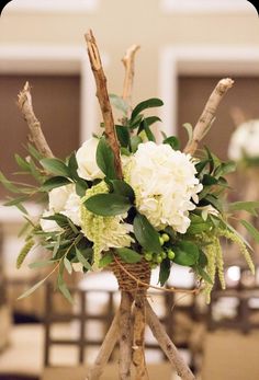 a vase filled with white flowers sitting on top of a table