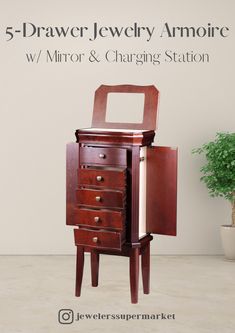 a wooden jewelry armoire with mirror and charging station in front of a white wall