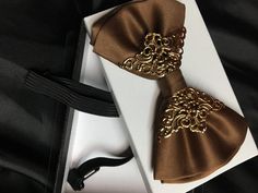 Luxury Satin Bow Tie For Semi-formal Occasions, Satin Ties With Decorative Bow For Party, Satin Bow Tie As Gift, Party Satin Ties With Decorative Bow, Elegant Gold Bow For Formal Occasions, Satin Bow Tie For Parties, Elegant Brown Bow Ties, Elegant Gold Tie With Decorative Bow, Dapper Brown Suit And Tie Accessories For Wedding