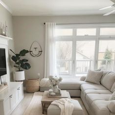 a living room filled with furniture and a flat screen tv