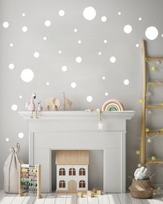 a child's room with white polka dot decals on the wall and a fireplace