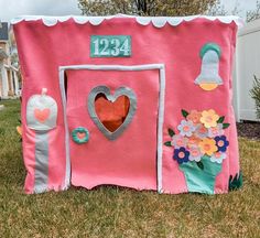 a pink house with flowers and hearts on it