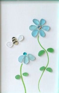 two blue flowers and a bee on a white background with green stems in the frame