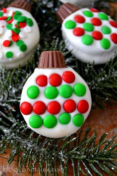 three decorated cupcakes sitting on top of a christmas tree