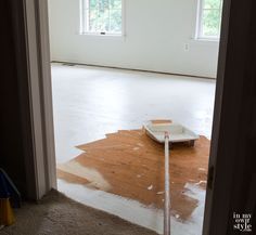 an empty room with a scale on the floor