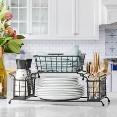 a kitchen counter with dishes and utensils stacked on top of eachother