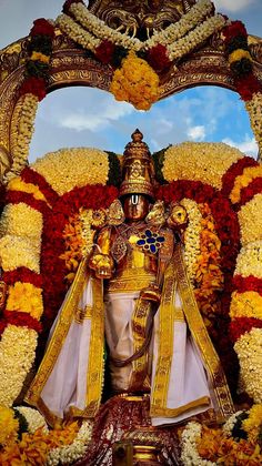 the statue is surrounded by flowers and garlands