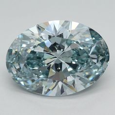 a very pretty blue diamond on a white surface