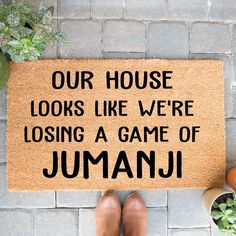 a door mat that says our house looks like we're losing a game of jumanji