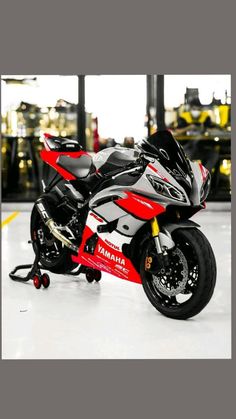 a red and white motorcycle parked in a garage