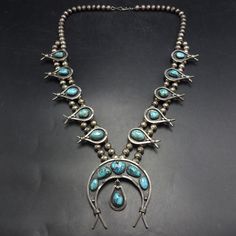 OLD PAWN MID CENTURY MODERN SQUASH BLOSSOM NECKLACE DESCRIPTION:  Circa 1950s with breathtaking specimens of natural blue turquoise, this necklace will be a valuable addition to your collection of the very finest Southwestern and Native American jewelry. MEASUREMENTS:  Necklace measures 27" end to end Naja measures 2 3/4" x 2 1/2" Beads are securely strung on silver foxtail chain WEIGHT:  208.2 grams SIGNED:  no STERLING:  unmarked verified STERLING Jewelry Measurements, Silver Squash Blossom Necklace, Squash Blossom Necklace, Squash Blossom, Jewelry Picture, Wedding Jewellery Necklace, American Jewelry, Native American Jewelry, Blue Turquoise