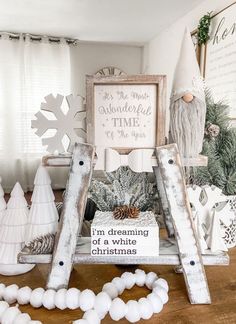 a christmas display with white snowflakes and wooden sleighs