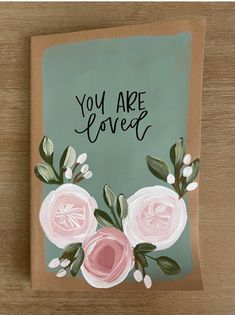 a card with flowers painted on it that says you are loved