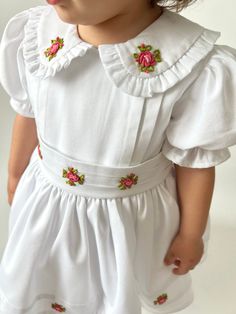 ✿ABOUT THIS DRESS ✓Our handmade dress is made from high-quality cotton fabric, this dress features a fluffy tutu-supported skirt lined with soft cotton for ultimate comfort. ✓The frilled collar and rib impositions on the front part of the dress and skirt add a touch of elegance, while the bow tie belt accentuates your child's waistline for a flattering fit.  ✓And flower embroideries adorning the dress - each hand-crafted with exquisite attention to detail by our skilled artisans.  ✿FABRIC INFORM Short Sleeve Embroidered Dress For Baptism, Embroidered Fitted Dress For Baptism, Fitted Embroidered Dress For Baptism, Fitted Floral Embroidery Baptism Dresses, Embroidered Fitted Dress For First Communion, Fitted Embroidered Dress For First Communion, White Doll Collar Dress With Floral Embroidery, White Floral Embroidery Dress With Doll Collar, White Floral Embroidered Dress For Baptism