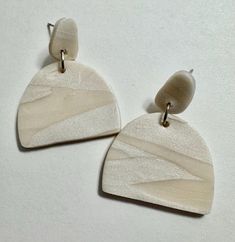 Simple two-toned, white geometric dangle earrings to go with every outfit Modern White Geometric Earrings, Trendy White Drop Earrings, Trendy Single White Earring, Trendy White Single Earring, Modern Single White Earring, Trendy White Dangle Earrings, Trendy Beige Drop Earrings, Modern White Earrings With Ear Wire, Chic Beige Drop Earrings