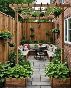 an outdoor patio with seating, potted plants and wooden fenced in arbors