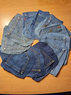 several pairs of jeans laid out on a table