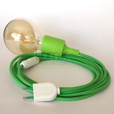 the green cord is plugged into an electric light bulb