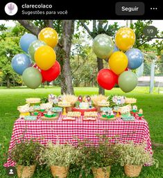 a table topped with lots of desserts and balloons