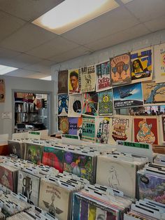 a room filled with lots of records and cds on the wall next to each other