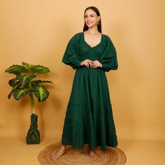 Bohemian medieval-inspired cotton dress with elastic under the bust for a perfectly fitted look. This Elegant piece has puffed sleeves tightened at the wrist with a wooden button. Soft, comfortable and breathable linen-look cotton.  Ideal top for a party, wedding or medieval celebration Free Size Main Color:  Bottle Green 100% Cotton First Wash Seperetly Machine wash 30o No Dryer Dry in the Shade to Protect the Color Handmade Delivered In A Cloth Pouch And Wrapped In Tissue Paper Ideal For Gifti Puff Sleeve Cotton Maxi Dress With Ruffles, Cotton Maxi Dress With Ruffles And Puff Sleeves, Cotton Maxi Dress With Gathered Puff Sleeves, Cotton Maxi Dress With Puff Sleeves, Peasant Prairie Dress With Ruffles For Gatherings, Cotton Peasant Prairie Dress With Ruffles, Cotton Prairie Dress With Ruffles In Peasant Style, Long Sleeve Cotton Peasant Dress, Green Bohemian Dress