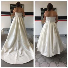 a woman in a white wedding dress looking at herself in the mirror and taking her own picture