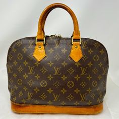 The Most Structured Of The Iconic Louis Vuitton Handbags, The Alma Was Originally Designed In The 1930s By Gaston-Louis Vuitton. Named After The Alma Bridge Over The River Seine, It Captures The Essence Of Parisian Chic In Monogram Canvas. Ideal For Contemporary Women, The Medium-Sized Alma Bag Will Hold All Everyday Essentials. Good Vintage Condition - Nice Patina On Leather With Some Darker Areas, As Shown, And Some Wear To Handles. Includes Dustbag And 3 Pc Luggage Tag. Date Code: Vi1914 Approximate Dimensions: 14”X11”X6.7” Please Note: Used Vintage Pieces May Have Lovely Patina Of Leather, Occasional Water Marks Or Other Areas Of Leather Darkening, Some Cracking Or Rubbing Of Leat Pre-owned Brown Monogram Canvas Bag, River Seine, Louis Vuitton Vintage, Water Marks, Vintage Monogram, Over The River, Bags Louis Vuitton, Vintage Louis Vuitton, Parisian Chic