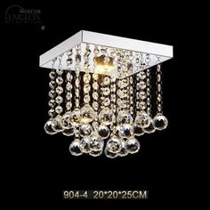 a chandelier hanging from the ceiling with crystal balls and chains attached to it