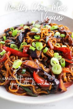 a white plate topped with noodles and veggies