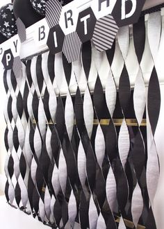 a black and white birthday decoration with ribbons