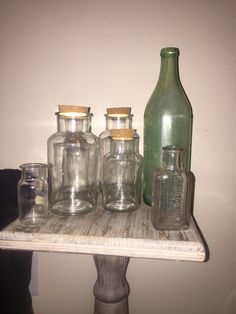 there are many glass bottles on the shelf