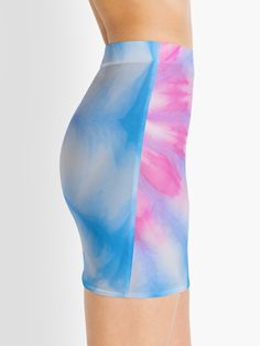 a woman in blue and pink tie dye shorts