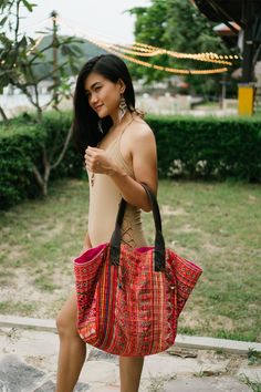 "The beautiful tote bag designed by oriental inspiration for lazy days at the beach and wandering around. It is made with an amazing piece of fabric woven by the HMONG hill tribes of Lanna Region (Northern Thailand). It features cotton lining, Leather Straps and a zipper closure. This bag will enhance your appearance. We buy materials from Hmong market and we design and sew by hand. Some of the bags we modify to improve the product. The Hmong tribes live in the North of Thailand and have origins Traditional Tote Beach Bag, Traditional Tote Beach Bag For Everyday Use, Bohemian Tote Beach Bag For Travel, Bohemian Beach Tote Bag For Travel, Bohemian Hobo Bag For Beach Season Travel, Bohemian Shoulder Bag For Beach Travel, Bohemian Shoulder Bag For Beach Season Travel, Bohemian Rectangular Hobo Bag For Beach Season, Red Handwoven Beach Bag For Travel