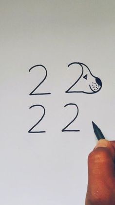 someone is writing numbers on a whiteboard with a dog's head drawn on it