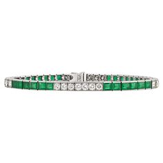 This sleek and elegant line bracelet from Tiffany & Co. features approximately 3.25 carats of emeralds accented by round white diamonds totaling approximately 1.80 carats. For over a century, the name Tiffany & Co. has been synonymous with beauty and luxury, qualities this bracelet possesses in abundance. Set in platinum. Marked "Tiffany & Co." on clasp 7 1/2" length Tiffany And Co Bracelet, Bracelet Tennis, Tiffany And Co, Emerald Diamond, Tennis Bracelet, Tiffany & Co., Diamond White, Arm Band, Diamond Bracelet