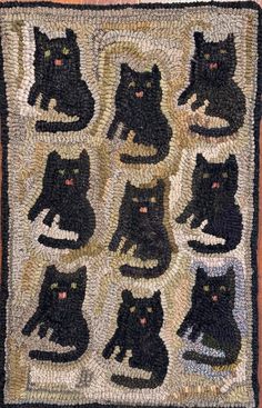 a rug with black cats sitting on top of it