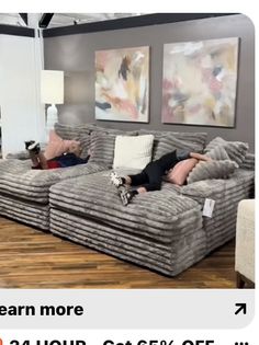 a woman laying on top of a couch in a living room