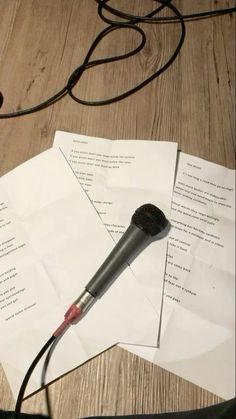 a microphone sitting on top of some papers