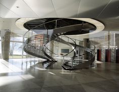 a spiral staircase in the middle of a large room