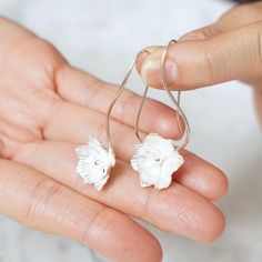 Chieko Yanai Fall in love with dignity and maturity! This pair of earrings features a beautiful anemone with delicate workmanship and texture. The softness of the silver wire work expresses the fragile beauty of the flower. The design is easy to match with a variety of occasions, from casual to formal. The name of the anemone flower comes from the Greek word "anemos," meaning wind. The anemone flower is named after the Greek word "anemos," meaning "wind," and the earrings are designed to sway ge Delicate Sterling Silver Birth Flower Earrings, Minimalist Sterling Silver Flower Earrings For Wedding, Delicate Sterling Silver Petal Jewelry, Delicate Sterling Silver Flower Earrings With Ear Wire, Sterling Silver White Birth Flower Earrings, Delicate Silver Petal Earrings, Minimalist Silver Flower Earrings For Wedding, Silver Minimalist Flower Earrings For Wedding, White Birth Flower Earrings In Sterling Silver