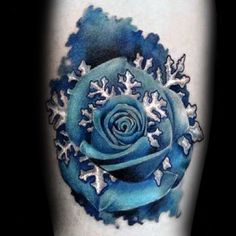 a blue rose tattoo with snowflakes on it