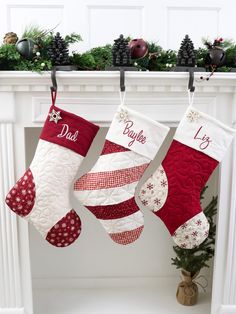 two christmas stockings hanging from a mantel