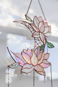 a stained glass flower hanging from chains