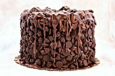 a cake with chocolate frosting and coffee beans on the top is shown in this image