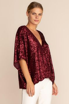 One of our most flattering silhouettes, the Concourse top is back in glittering ruby-colored sequins. Featuring a low surplice neckline and fluttery, dolman sleeves, this sparkling top is perfect for a holiday get-together at home or away. Surplice neckline Dolman sleeves Model in Garnet Red 5'10", wearing size M Model in Emerald Green is 5'10", wearing size S All That Glitters Sequins Dry Clean Only Imported Red Sequin Top, Sparkly Top, Garnet Red, Surplice Neckline, Red Sequin, All That Glitters, Trina Turk, Sequin Top, Red Garnet