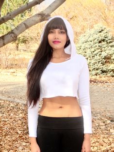 "This white long sleeve cropped hoodie has a soft feel and a stylish and edgy fit that is loose-fitting and comfortable. This boxy crop top is made from a soft fleece fabric.  Best paired with: Cutoff shorts, your favorite pair of jeans, a nice mini-skirt, or your favorite exercise wear and lounge wear. The model is 5'3\" and wearing a size small.  Keep in mind that this top, especially in small, is very short; order a size up if you want the top to be longer. Size Chart (inches):                              S                  M           L Bust                      26-31   32-35    35-38 Natural Waist      26            36    36 Length                      12             16     16  Materials:  30% cotton, 70% polyester. Custom print on this crop top: Yes. You can request your own design Winter Cotton Stretch Crop Top, Winter Stretch Cotton Crop Top, Spring Cropped Sweater With Drawstring Hood And Long Sleeves, White Long Sleeve Cropped Sporty Sweater, White Long Sleeve Crop Top For Winter, White Cropped Sweatshirt For Winter, Stretch Long Sleeve Cropped Sweater For Streetwear, White Casual Cropped Sweater, White Stretch Cropped Sweater