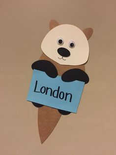 a paper cut out of a bear holding a london sign