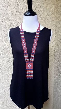 Colorful long shiny Native American seed bead necklace with fun fringe in a striking pattern. This necklace says summer, beach, resort. Necklace measures 16 inches, pendant measures 4 1/2 inches from top to the bottom of the fringe. No clasp, just slip over your head. Striking with a swingy beach dress or a jean jacket. Shop more necklaces here: https://www.etsy.com/shop/BoutiqueByMaryam?section_id=21694658 Be sure to visit the rest of my shop here: https://www.etsy.com/shop/boutiquebymaryam Artisan Beaded Fringe Necklaces For Festivals, Southwestern Beaded Necklace With Dangling Beads For Festivals, Beaded Tassel Necklace For Festivals, Southwestern Style Festival Beads With Dangling Details, Artisan Necklace With Beaded Fringe For Festivals, Multicolor Beaded Lariat Necklace With Round Beads, Bohemian Lariat Beaded Necklaces With Colorful Beads, Bohemian Lariat Beaded Necklace With Colorful Beads, Artisan Lariat Necklace For Festivals