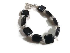 This bracelet created by Jewelry By Carmal is made of: black onyx gemstones, sterling silver: beads, toggle and findings. This bracelet measures 7 1/2 inches in length. View more beaded bracelets: http://www.etsy.com/shop/jewelrybycarmal?section_id=8002918 All of our jewelry arrives wrapped and ready for gift giving! We offer free standard shipping (via USPS) within the United States. Black Beaded Sterling Silver Bracelets, Nickel Free Black Beaded Bracelets For Crafting, Smoky Quartz Jewelry, Ethiopian Opal Jewelry, Yellow Bracelet, Beading Jewelery, Brown Bracelet, Black Bracelet, Jewelry Beaded